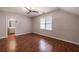Spacious bedroom with wood floors, ceiling fan, and adjoining bathroom at 3117 Kings Arms Ne Ct, Atlanta, GA 30345