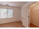 Bedroom with light wood floors, a window with blinds, and closet with shelving at 3117 Kings Arms Ne Ct, Atlanta, GA 30345