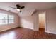 Bedroom featuring hardwood floors, a ceiling fan, and a window overlooking the yard at 3117 Kings Arms Ne Ct, Atlanta, GA 30345