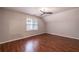 Bedroom with wood floors, a window, and a modern ceiling fan at 3117 Kings Arms Ne Ct, Atlanta, GA 30345
