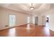 Large bedroom with hardwood floors, tray ceiling, recessed lighting, and an entrance to another room at 3117 Kings Arms Ne Ct, Atlanta, GA 30345