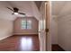 Bedroom with hardwood floors, a ceiling fan, and an open closet with shelving at 3117 Kings Arms Ne Ct, Atlanta, GA 30345