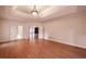 Large bedroom featuring hardwood floors, tray ceiling, recessed lighting, and an entrance to another room at 3117 Kings Arms Ne Ct, Atlanta, GA 30345