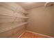 This walk-in closet has wooden floors and extensive wire rack shelving for optimal storage at 3117 Kings Arms Ne Ct, Atlanta, GA 30345