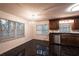 Bright dining area with dark wood cabinets, black tile floors, and modern lighting at 3117 Kings Arms Ne Ct, Atlanta, GA 30345