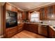Kitchen featuring granite countertops, wood cabinets, stainless steel appliances, and hardwood floors at 3117 Kings Arms Ne Ct, Atlanta, GA 30345