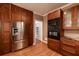 Kitchen with stainless steel appliances, dark wood cabinets, granite countertops, and hardwood floors at 3117 Kings Arms Ne Ct, Atlanta, GA 30345