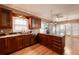 Gourmet kitchen featuring granite countertops, wood cabinets, stainless steel appliances, and hardwood floors at 3117 Kings Arms Ne Ct, Atlanta, GA 30345