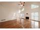 Bright living room with hardwood floors, fireplace, large windows, and a ceiling fan at 3117 Kings Arms Ne Ct, Atlanta, GA 30345