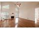 Bright living room with hardwood floors, fireplace, large windows, and a ceiling fan at 3117 Kings Arms Ne Ct, Atlanta, GA 30345