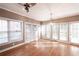 Bright living room with hardwood floors, many windows, and a ceiling fan and chandelier at 3117 Kings Arms Ne Ct, Atlanta, GA 30345