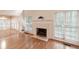 Living room showcasing a fireplace and natural light from the windows overlooking the exterior scenery at 3117 Kings Arms Ne Ct, Atlanta, GA 30345