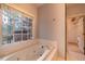 Inviting main bathroom with tub next to a large picture window at 3117 Kings Arms Ne Ct, Atlanta, GA 30345