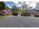 Wide shot of street, houses feature brick exteriors, manicured lawns, and garage access at 3117 Kings Arms Ne Ct, Atlanta, GA 30345