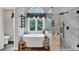 Bright bathroom featuring a soaking tub, large window, and separate shower with decorative stone tile flooring at 2138 Jockey Hollow Nw Dr, Kennesaw, GA 30152