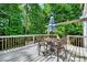 Outdoor deck featuring patio furniture, a table with an umbrella, and a wooded view at 2138 Jockey Hollow Nw Dr, Kennesaw, GA 30152