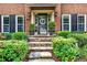 Stone steps leading up to front door with decorative wreath and lush landscaping at 2138 Jockey Hollow Nw Dr, Kennesaw, GA 30152