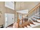 Bright foyer featuring hardwood floors, a staircase, and a high ceiling at 2138 Jockey Hollow Nw Dr, Kennesaw, GA 30152