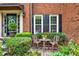 Cozy front porch with seating area and charming brick details at 2138 Jockey Hollow Nw Dr, Kennesaw, GA 30152
