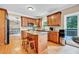 View of the kitchen area with granite countertops, wood cabinets, stainless appliances, and a center island at 2138 Jockey Hollow Nw Dr, Kennesaw, GA 30152