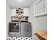 Laundry room with washer, dryer, white cabinets, and decorative star-patterned flooring at 2138 Jockey Hollow Nw Dr, Kennesaw, GA 30152