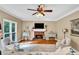 Living room with a brick fireplace, hardwood floors, large window, ceiling fan, and furniture at 2138 Jockey Hollow Nw Dr, Kennesaw, GA 30152