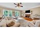 Spacious living room featuring a fireplace, hardwood floors, large windows, and comfortable seating at 2138 Jockey Hollow Nw Dr, Kennesaw, GA 30152