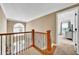 Hallway area featuring oak trimmed stair case and railing with views to an upstairs bedroom at 2138 Jockey Hollow Nw Dr, Kennesaw, GA 30152