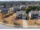 An aerial view of a residential neighborhood showcasing a charming two-story brick home at 5035 Lloyd Ln, Cumming, GA 30040