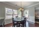 Inviting breakfast nook with dark wood table and lots of sunlight at 5035 Lloyd Ln, Cumming, GA 30040