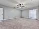 Large bedroom with neutral carpet, ceiling fan, and walk-in closet for ample storage at 5090 Eubanks Rd, Woodstock, GA 30188