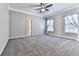 Spacious bedroom featuring gray carpet, two windows, crown molding, and ensuite bathroom at 5090 Eubanks Rd, Woodstock, GA 30188