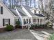 Charming two-story home with white siding, black shutters, and a welcoming front porch at 5090 Eubanks Rd, Woodstock, GA 30188