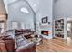 Spacious living room with hardwood floors, vaulted ceiling, fireplace, and built-in bookshelves at 5090 Eubanks Rd, Woodstock, GA 30188