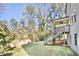 Backyard showing staircase leading to the house with a well-maintained lawn at 1300 Winfair Ne Ln, Brookhaven, GA 30329