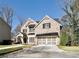 Attractive two-story home boasts brick facade, manicured lawn, and a two-car garage at 1300 Winfair Ne Ln, Brookhaven, GA 30329