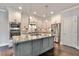 Modern kitchen with stainless steel appliances, granite counters, and custom cabinetry at 1300 Winfair Ne Ln, Brookhaven, GA 30329