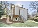 Back of the house with stairs leading to a second story entrance and daylight basement at 1300 Winfair Ne Ln, Brookhaven, GA 30329