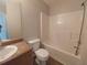 Cozy bathroom with a white vanity, toilet, and shower-tub with tile surround at 315 Dressage Ct, Riverdale, GA 30296