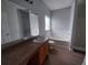 Bathroom with large mirror, vanity, bathtub, and a window for natural light at 315 Dressage Ct, Riverdale, GA 30296