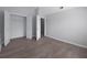 This bedroom features neutral walls, wood-look floors, and a closet with white doors at 315 Dressage Ct, Riverdale, GA 30296