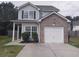 Charming two-story home with a brick-accented garage and well-maintained front yard at 315 Dressage Ct, Riverdale, GA 30296