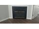 Cozy fireplace with glass doors and detailed trim, set against wood-look floors at 315 Dressage Ct, Riverdale, GA 30296