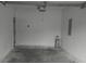 Empty garage with concrete floors, white walls, and an automatic door opener at 315 Dressage Ct, Riverdale, GA 30296
