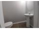 Compact half-bathroom with pedestal sink, modern fixtures, and light-colored walls at 315 Dressage Ct, Riverdale, GA 30296