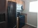 Modern kitchen features stainless steel refrigerator, gas range, and overhead microwave at 315 Dressage Ct, Riverdale, GA 30296