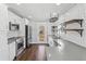 Modern kitchen featuring stainless steel appliances, subway tile backsplash, and floating shelves at 1683 Emerald Sw Ave, Atlanta, GA 30310