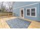 A beautiful back deck features wood railing and room for entertaining as well as access to a door into the house at 263 Ohm Ave, Avondale Estates, GA 30002