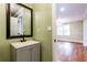 Bathroom features a vanity sink with a black faucet, a mirror, and a light green painted wall at 263 Ohm Ave, Avondale Estates, GA 30002