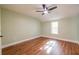 An airy bedroom featuring light green walls, hardwood floors, ceiling fan and a window that invites plenty of natural light at 263 Ohm Ave, Avondale Estates, GA 30002